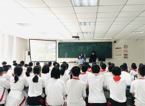 图片：日立高新技术（上海）国际贸易有限公司的志愿者老师徐双俐和李佳婧在讲解日立电子显微镜知识